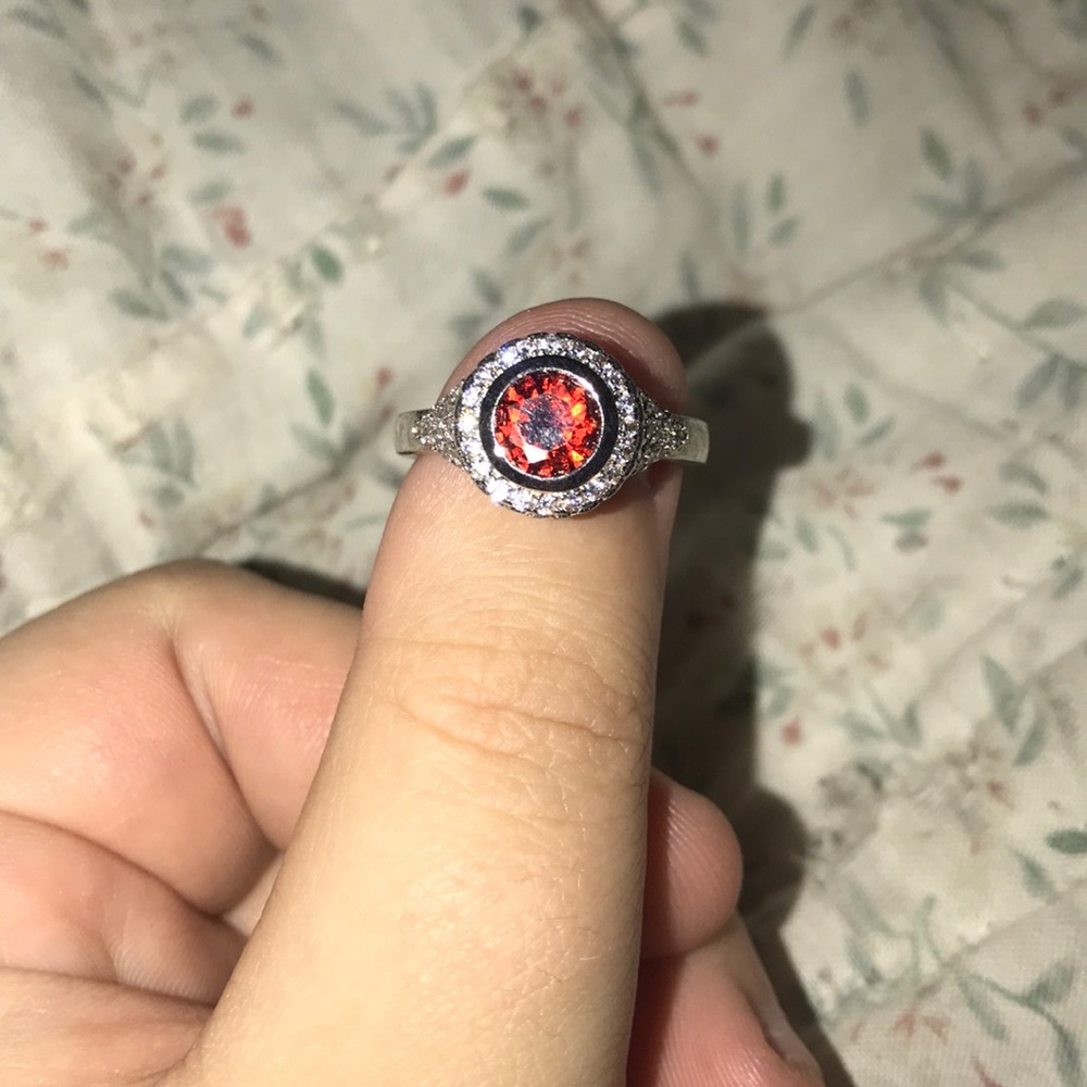 Beautiful red ring with diamonds around